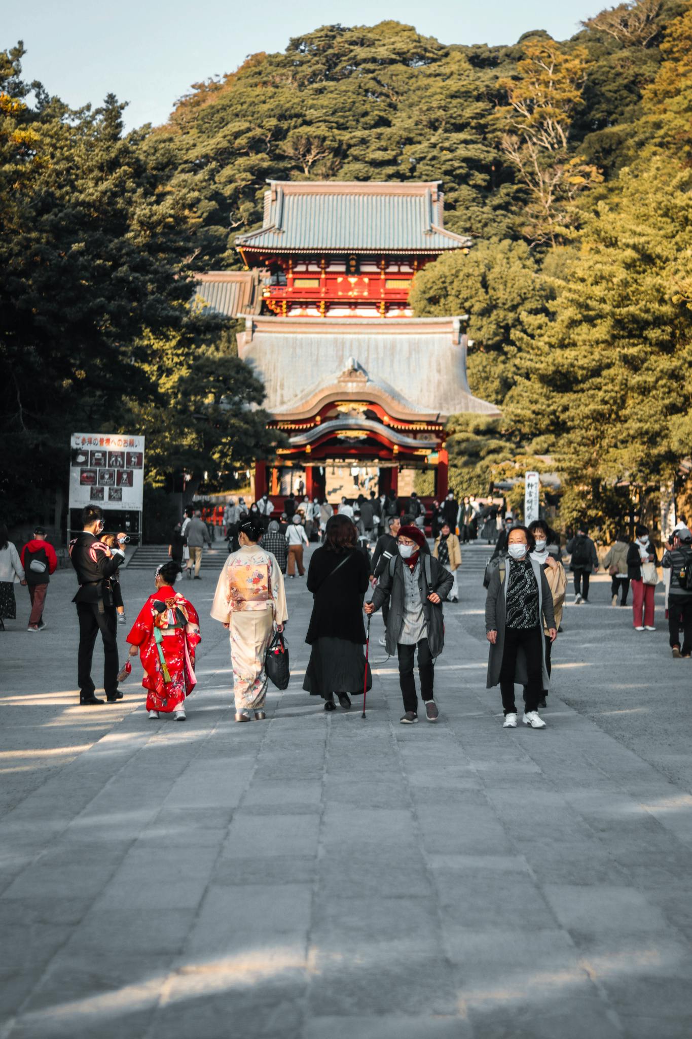 Visitors in traditional attire at Tsurugaoka Hachimangu Shrine, Kamakura, capturing cultural richness.